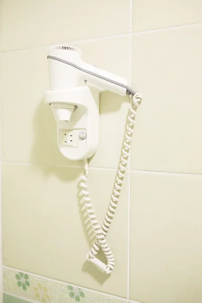Hairdryer hanging on the wall — Stock Photo, Image
