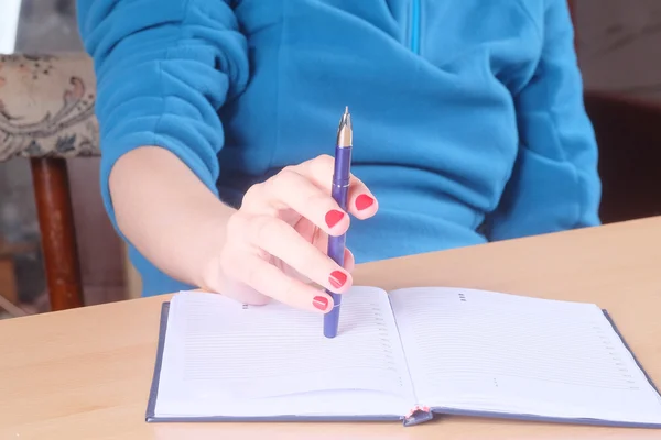 Hand with pen and notebook — Stock Photo, Image