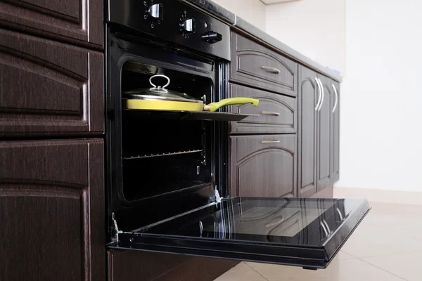 Open oven and yellow frying pan — Stock Photo, Image