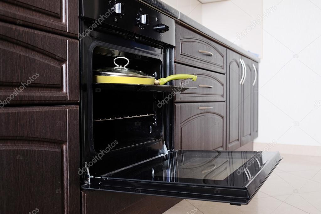 Open oven and yellow frying pan