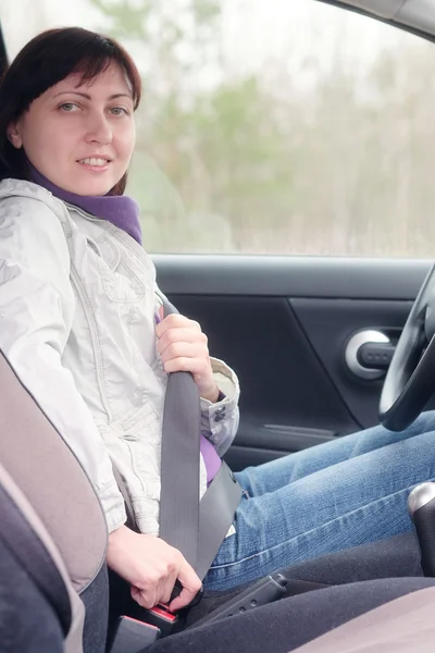 Kvinna att sätta på säkerhetsbältet — Stockfoto