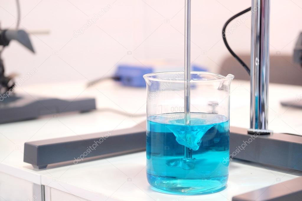 Blue chemical substance in beaker.