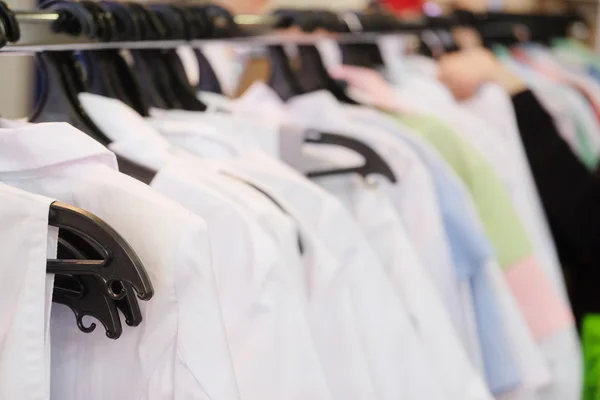 Clothes on the hangers in a shop — Stock Photo, Image