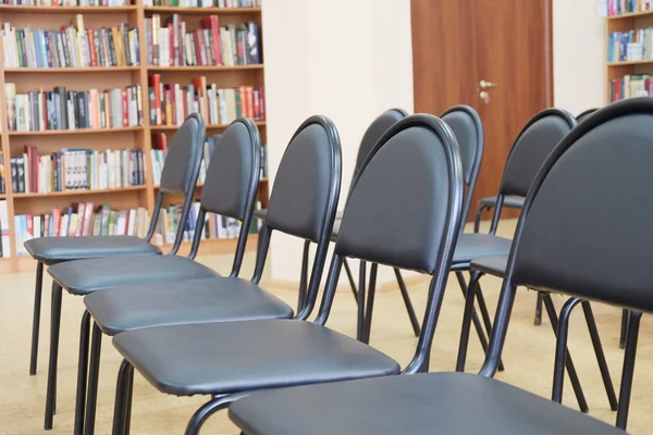 Filas de sillas negras en el pasillo — Foto de Stock