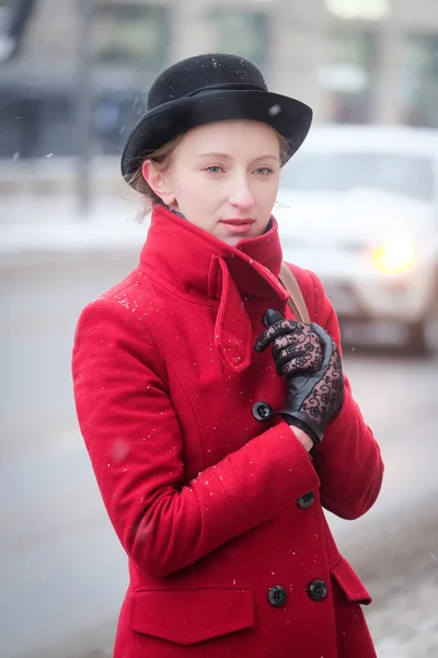 Girl in a red coat — Stock Photo, Image