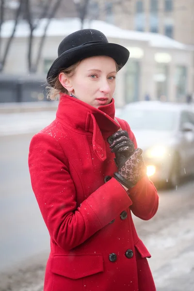 Girl in a red coat — Stock Photo, Image