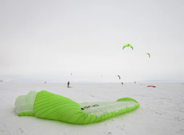 Kiteboarder with blue kite on the snow — Stock Photo, Image