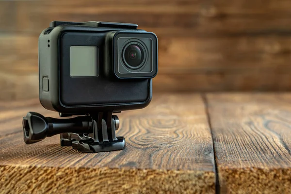 action camera on wooden background