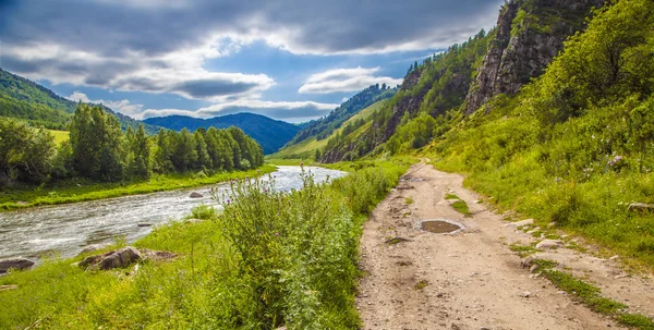 Road near river under cloudy sky — Stock Photo, Image