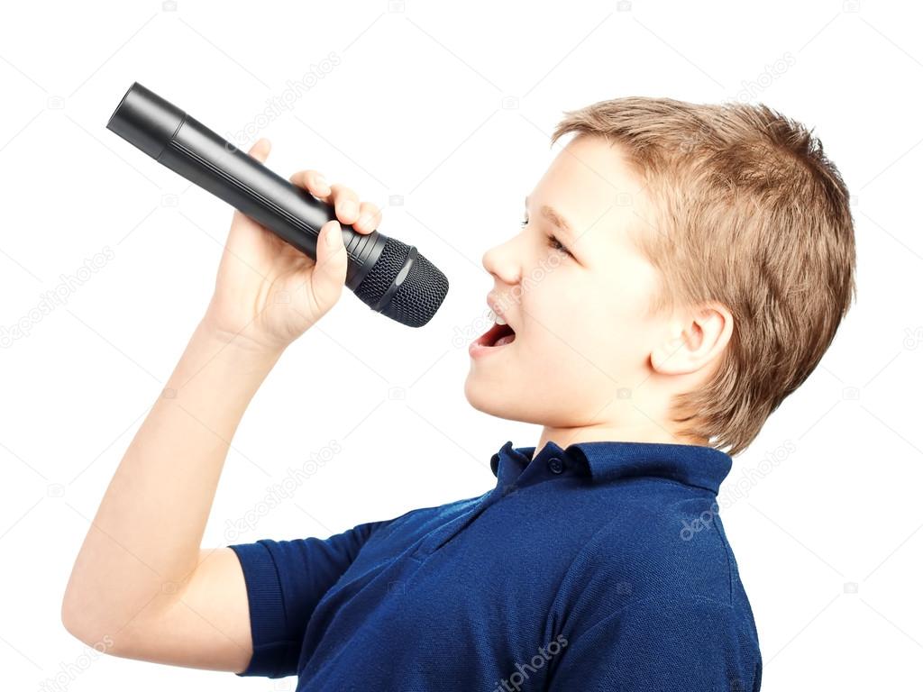 Boy singing into a microphone. Very emotional.