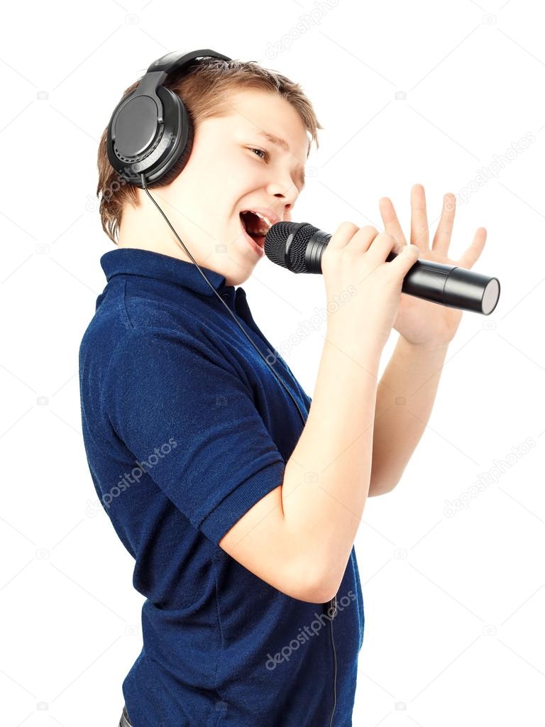 Boy singing into a microphone. Very emotional.