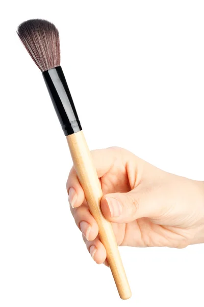 Escova de maquiagem na mão — Fotografia de Stock