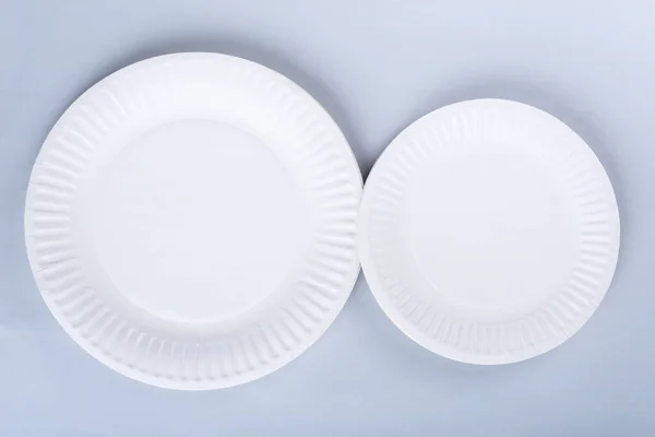 Two disposable plates on light blue background — Stock Photo, Image