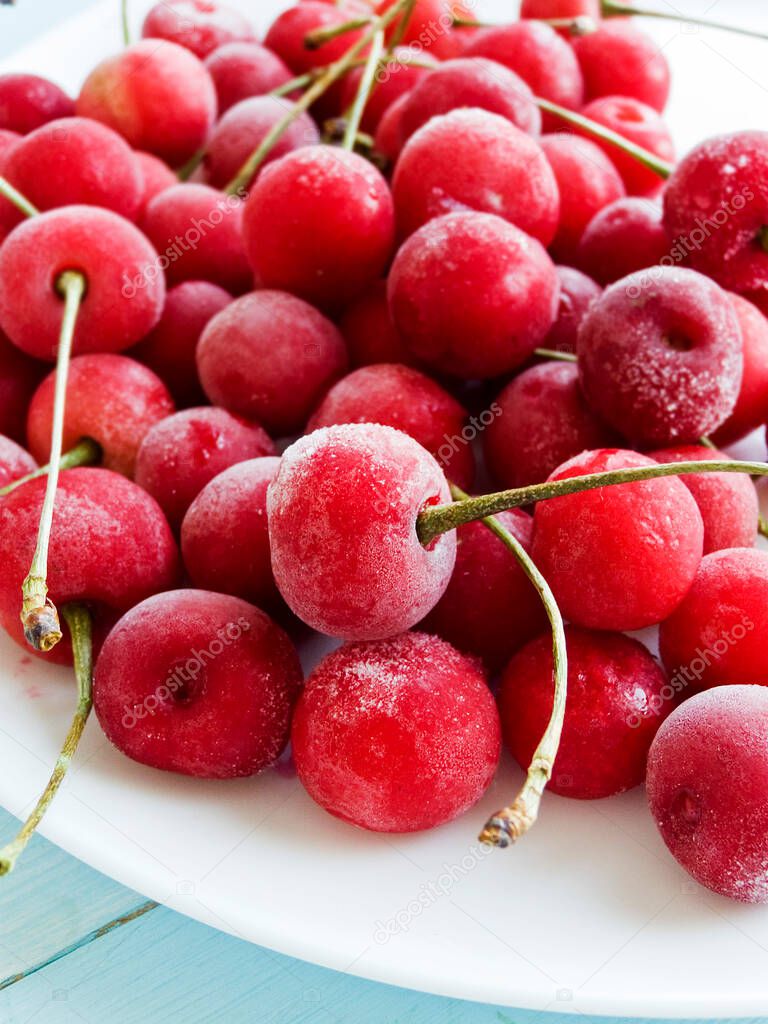 Freshl frozen cherry berries on a wooden background. Shallow dof.