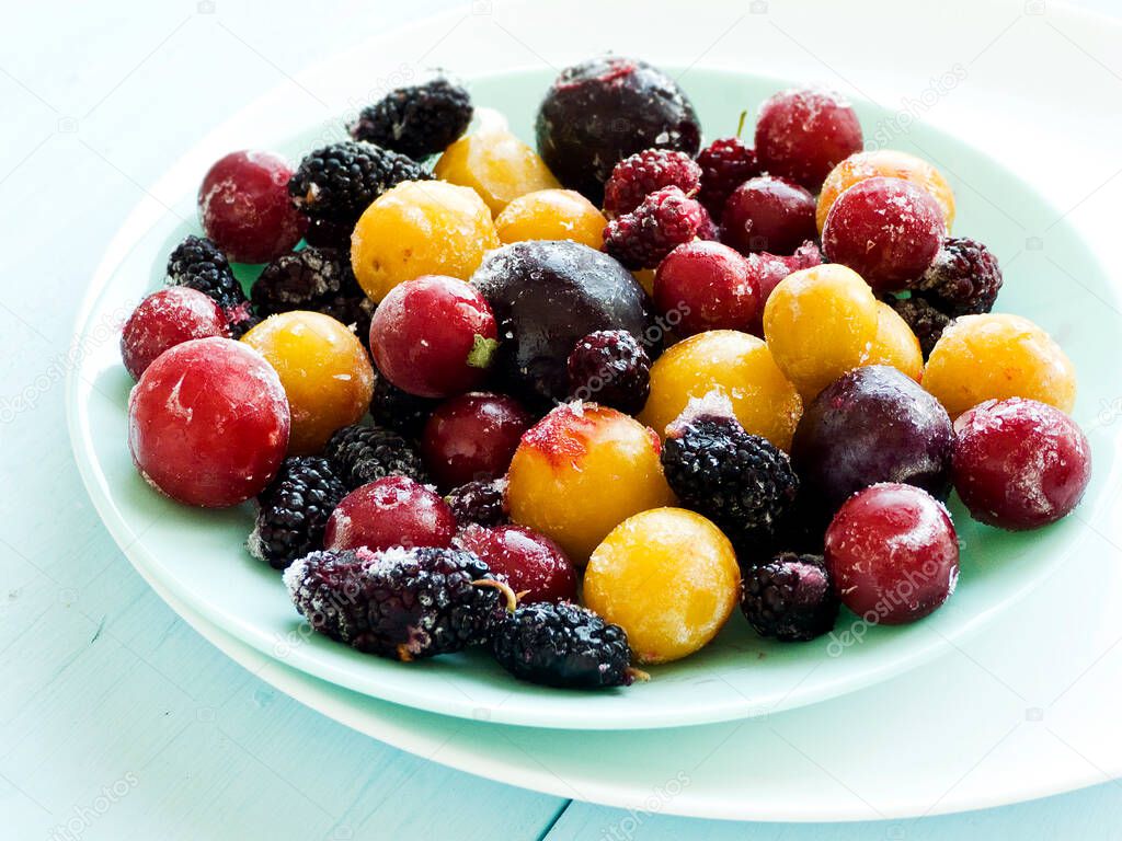 Freshl frozen berries on a wooden background. Shallow dof.