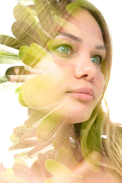 Un ritratto tropicale foglie doppia esposizione di una giovane donna dagli occhi azzurri riflessivo su sfondo bianco — Foto Stock