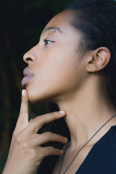 A portrait of a woman with her finger at her chin — Stock Photo, Image