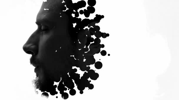 Ett svart och vitt dubbelexponerat porträtt av en mans profil kombinerat med svarta penseldrag — Stockvideo
