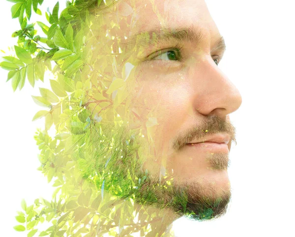 Photo de plantes vertes lumineuses et portrait d'un jeune homme — Photo