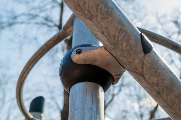 type of fastening connection of metal pipes with metal support in children equipment for recreation on playground. stainless steel mounting elements and clamps. Technical design of playground decoration