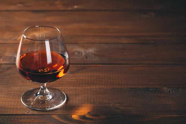Glass of cognac on table — Stock Photo, Image