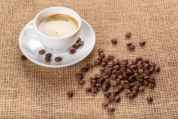 White coffee cup and coffee beans — Stock Photo, Image