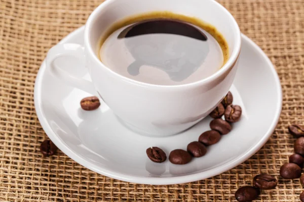 White coffee cup and coffee beans — Stock Photo, Image