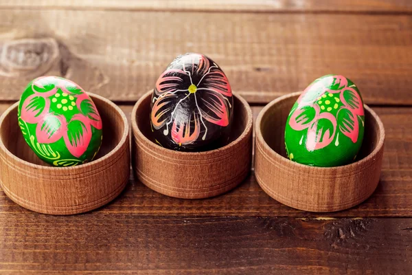 Painted Easter eggs in little wooden nests — Stock Photo, Image