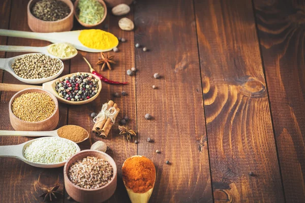 Colorful spices in wooden spoons — Stock Photo, Image