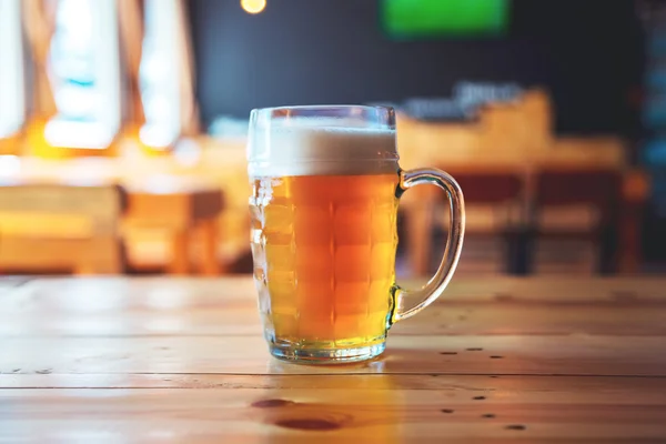 Cerveja em um balcão de madeira bar no pub — Fotografia de Stock