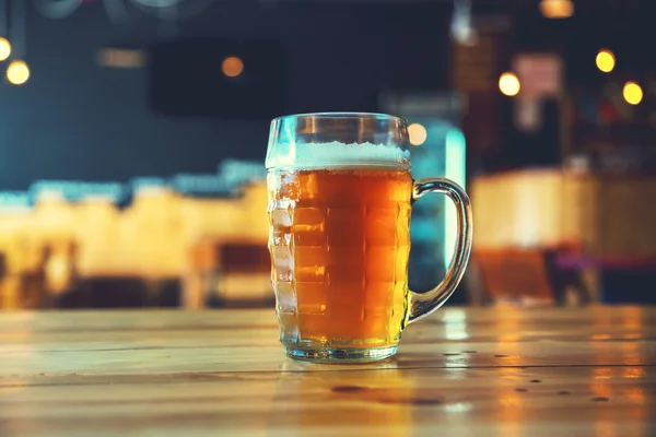 Beer on a wooden bar counter in pub — Stock Photo, Image