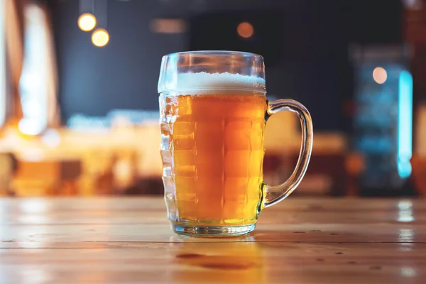 beer on a wooden bar counter in pub