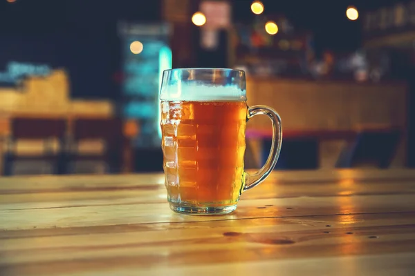 Beer on a wooden bar counter in pub — Stock Photo, Image