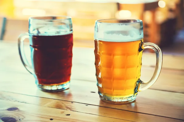 Beer on a wooden bar counter in pub — Stock Photo, Image