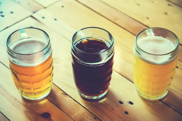 Beer on a wooden bar counter in pub — Stock Photo, Image