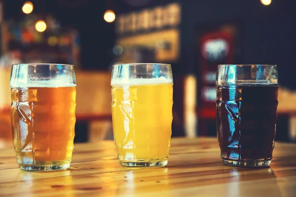 Beer on a wooden bar counter in pub — Stock Photo, Image