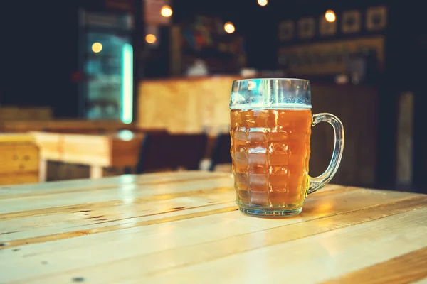 Cerveja em um balcão de madeira bar no pub — Fotografia de Stock