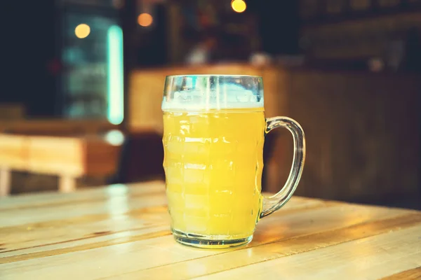 Beer on a wooden bar counter in pub — Stock Photo, Image