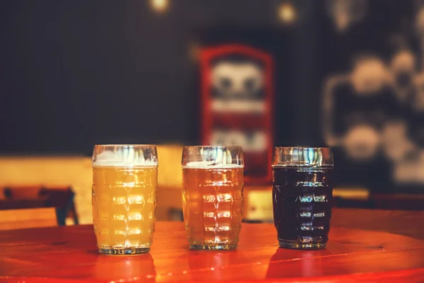 beer on a wooden bar counter in pub