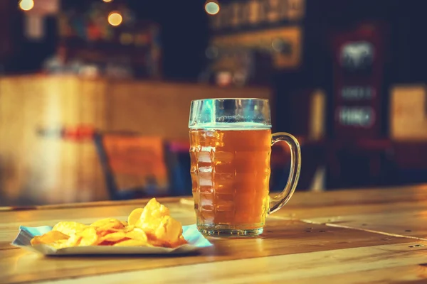 Beer on a wooden bar counter in pub — Stock Photo, Image
