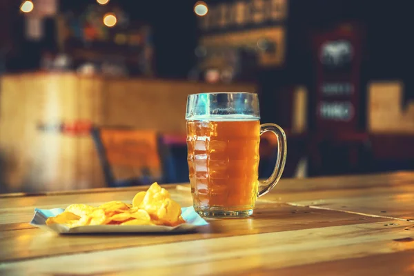 Beer on a wooden bar counter in pub — Stock Photo, Image