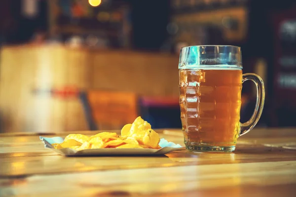 Beer on a wooden bar counter in pub — Stock Photo, Image