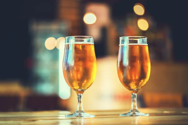 Beer on a wooden bar counter in pub — Stock Photo, Image