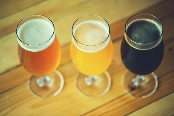 Beer on a wooden bar counter in pub — Stock Photo, Image