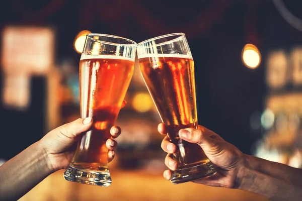 beer on a wooden bar counter in pub