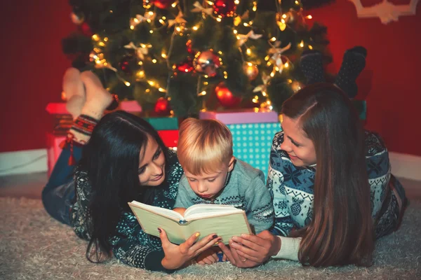 Young family near Christmas tree