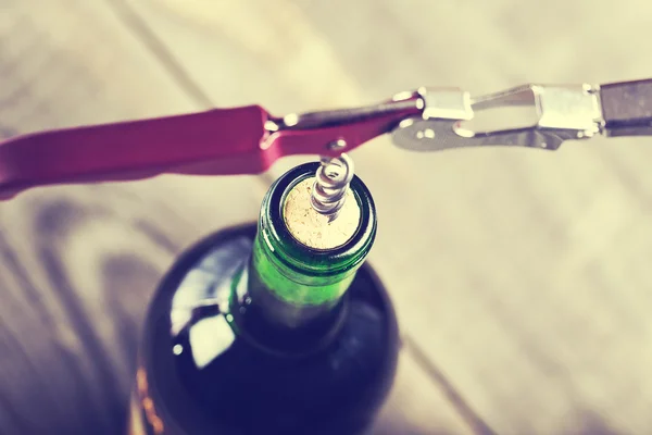 Bottle of wine with corkscrew — Stock Photo, Image