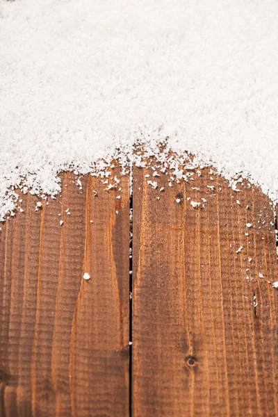 Kerstmis sneeuw op houten achtergrond — Stockfoto