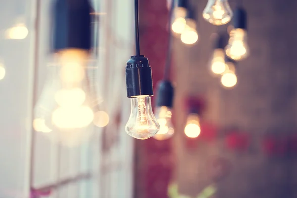 Light bulbs hanging at window — Stock Photo, Image