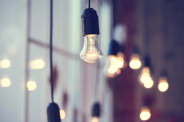 Light bulbs hanging at window — Stock Photo, Image